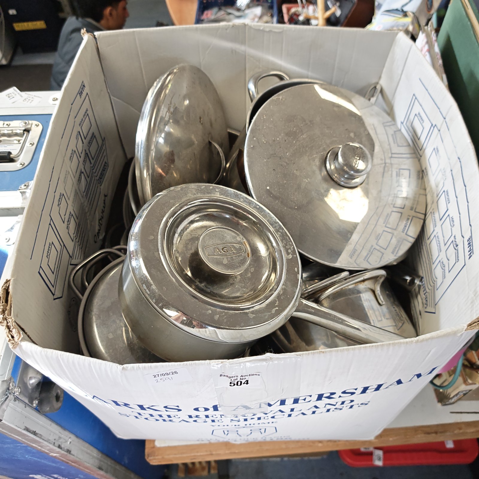 Large collection of stainless steel pots and pans for kitchen use.