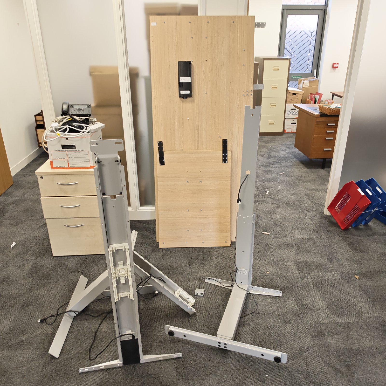 Adjustable standing desk with wooden top and steel frame.