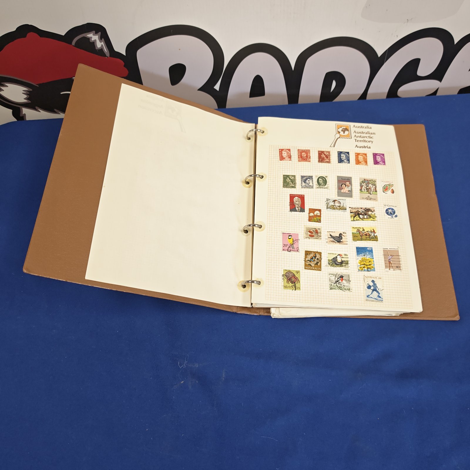 Vintage Stanley Gibbons stamp album with open pages displaying stamps.