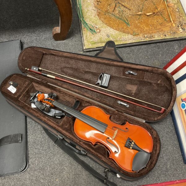 Stentor student violin in open case with bow and tuner.