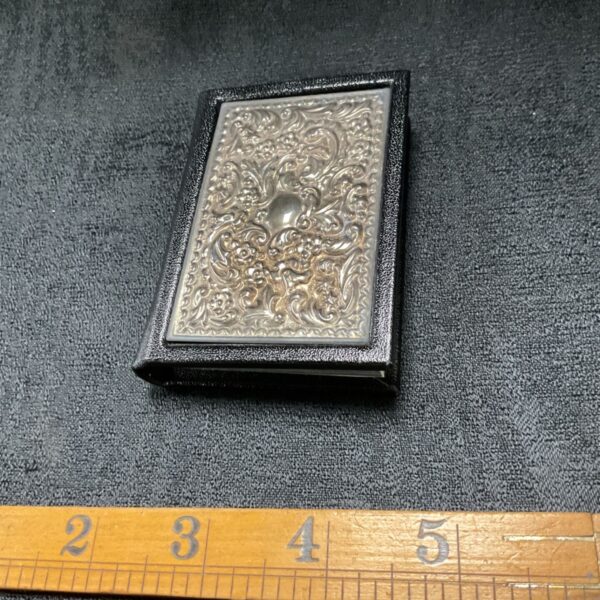 Antique sterling silver birthday book with astrological notes and embossed cover.