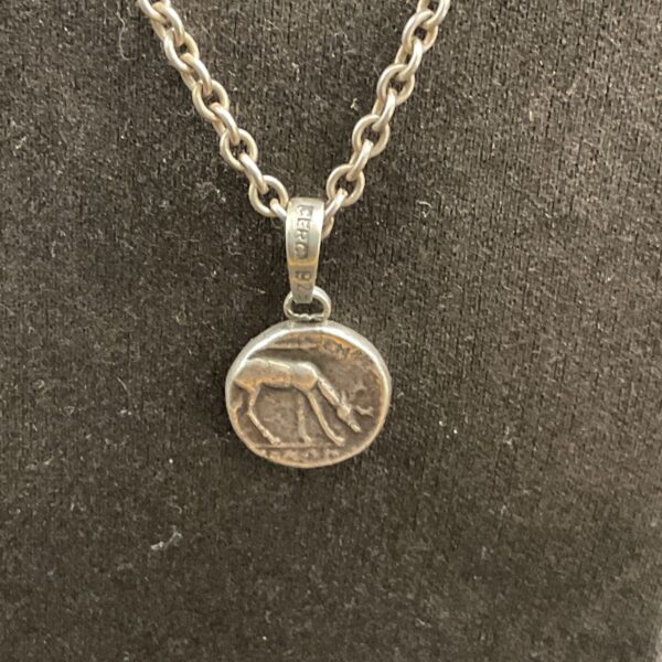 Close-up of sterling silver pendant necklace with deer design.
