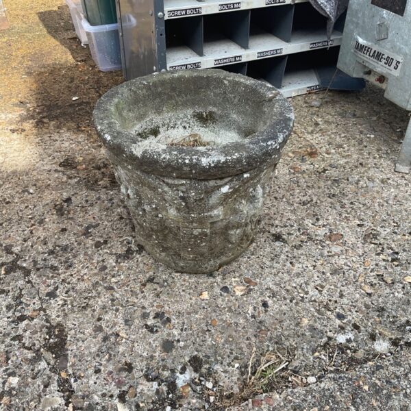 Weathered stone effect garden planter for outdoor plants.
