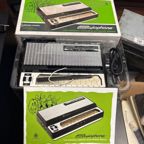 Boxed vintage Stylophone pocket organ, a retro electronic instrument.
