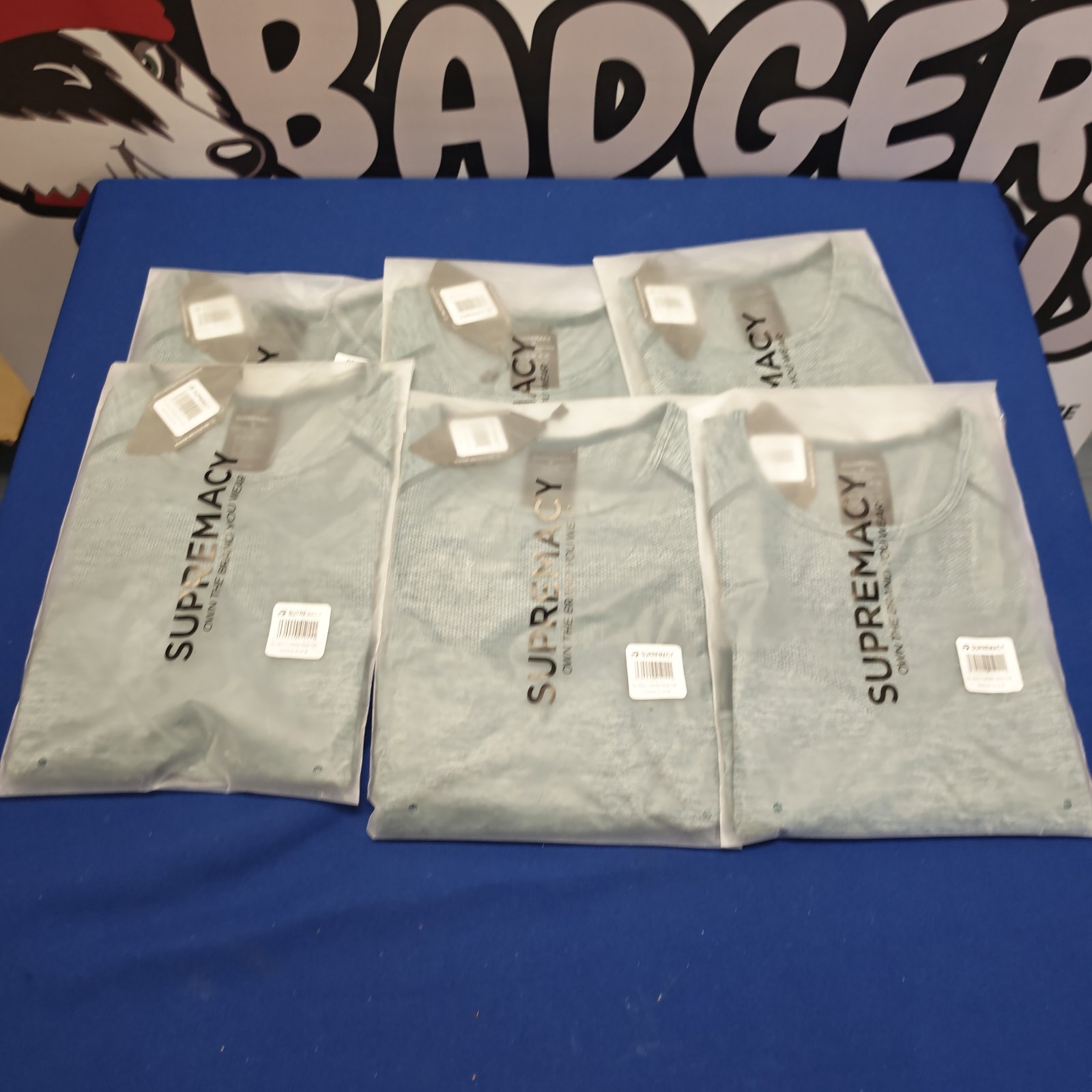 Unopened lot of six Supremacy gym cross tops for fitness.