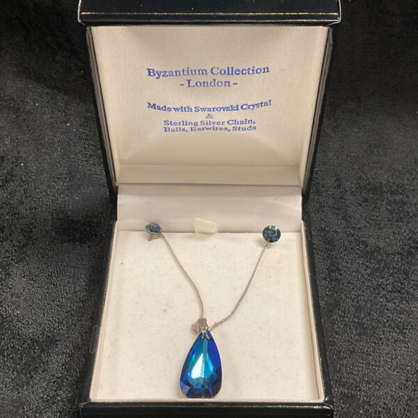 Swarovski Byzantium necklace and earrings set with a blue crystal pendant.