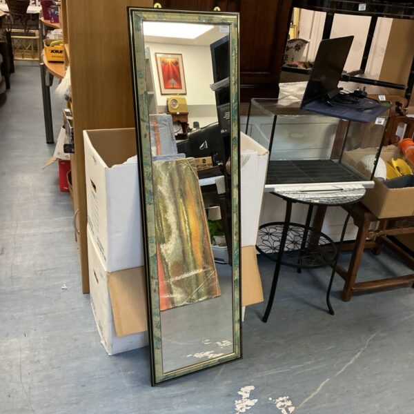 Tall framed wall mirror with distressed finish.