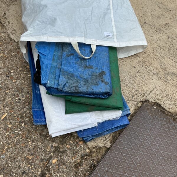 Assorted tarpaulins in a bag, a useful lot of waterproof covers.