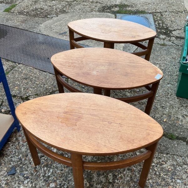 Vintage teak nesting tables set in a mid-century modern style.