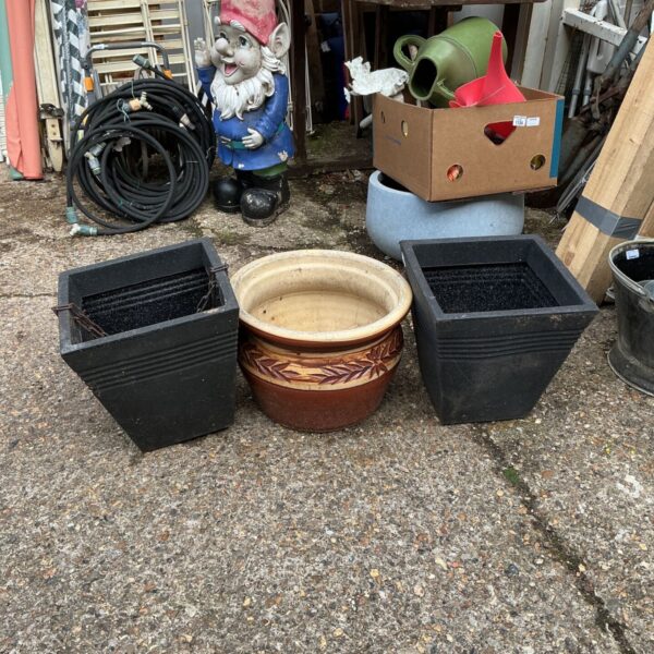 Garden lot featuring a terracotta pot and two plastic tubs.