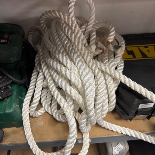 Thick braided nylon rope coiled, suitable for heavy duty tasks.