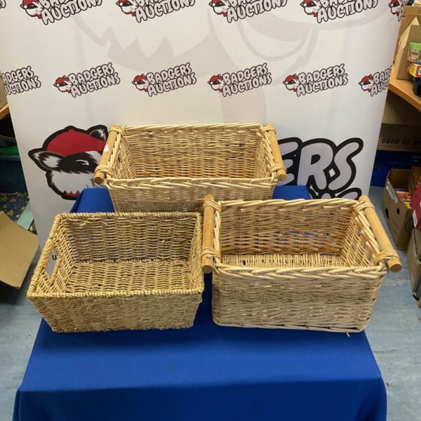 Three vintage wicker baskets for storage and display.