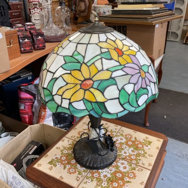 Vibrant Tiffany style table lamp with a floral stained glass shade.