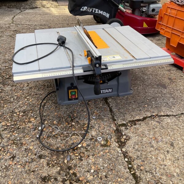 Portable Titan bench saw with folding legs and blade guard.