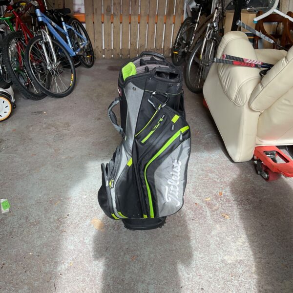 Grey and green Titleist golf bag with stand, ideal for golf outings.