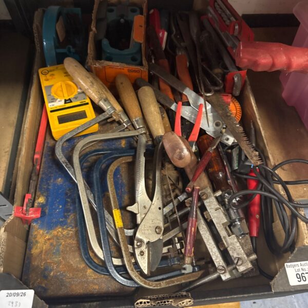 Vintage tool selection with electrical multimeter for workshop use.
