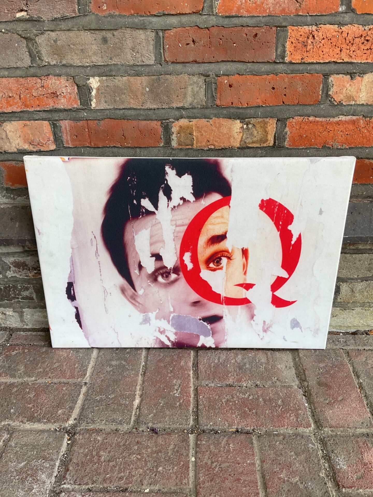 697 Canvas print featuring a torn portrait with bold red Q graphic overlay