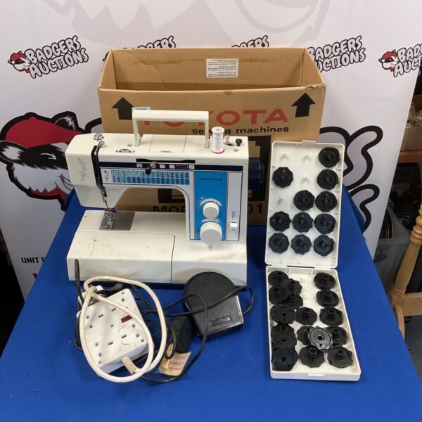 Vintage Toyota 2701 sewing machine with accessories.
