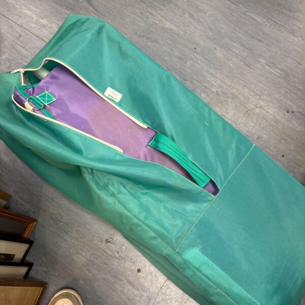 Green Travelite travel cot cover with zip closure.