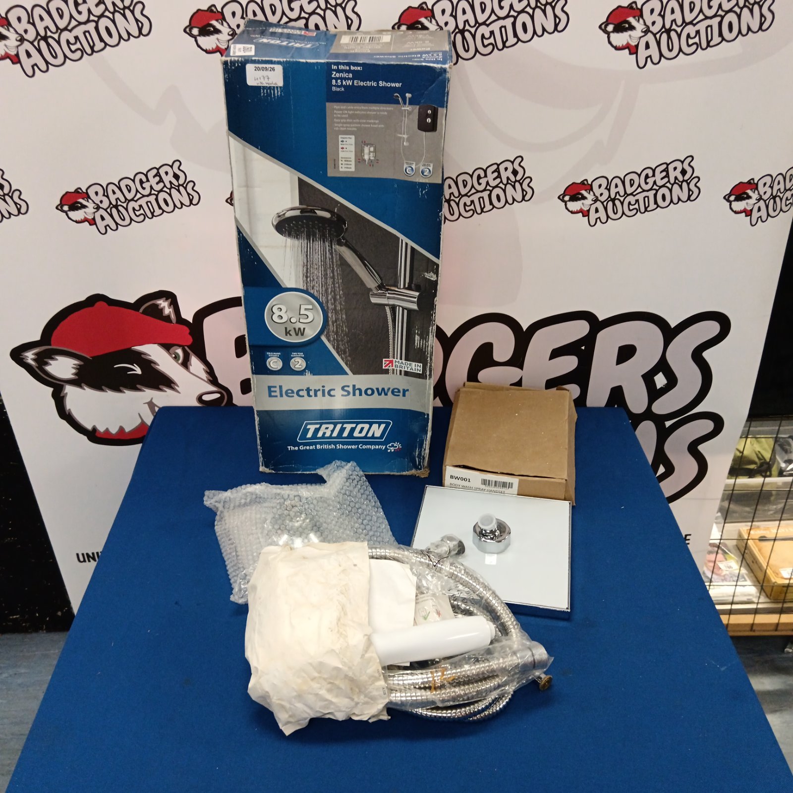 Boxed Triton Zenica 8.5kW electric shower with accessories.