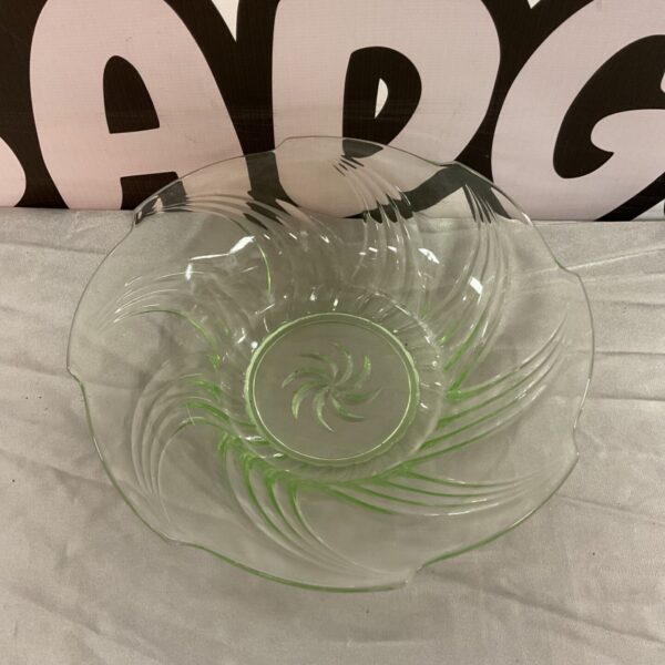 Vintage green uranium glass bowl with spiral design.