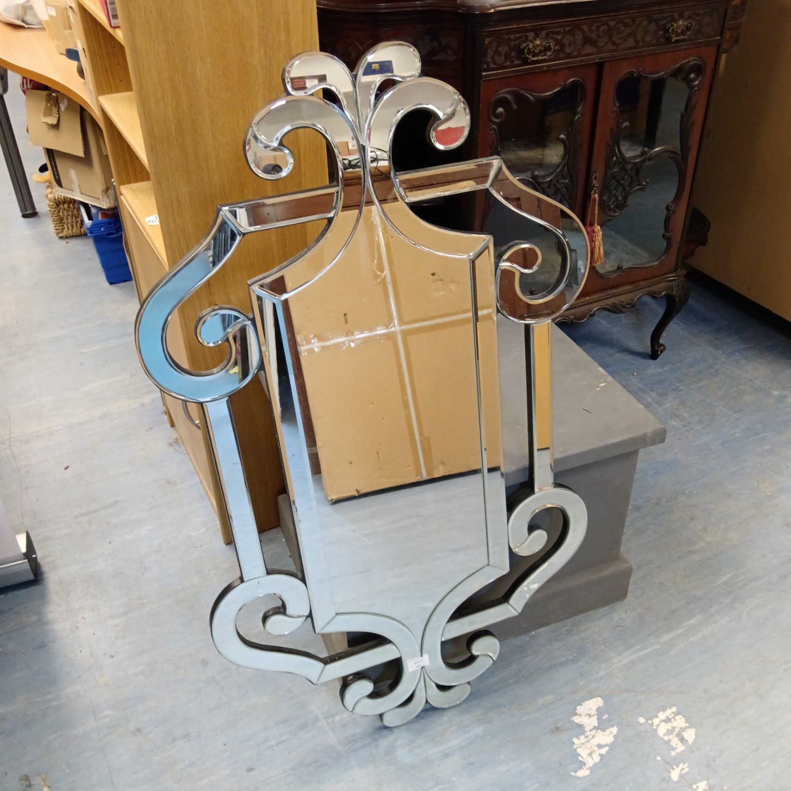Ornate Venetian wall mirror with bevelled glass and fleur-de-lis detail.