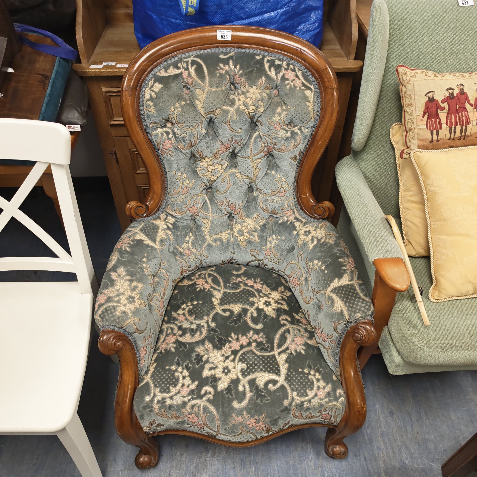 Antique Victorian armchair with floral upholstery and carved wood.