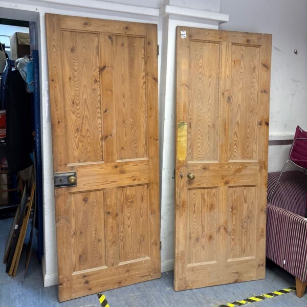 Victorian interior door pair with original hardware and aged wood.