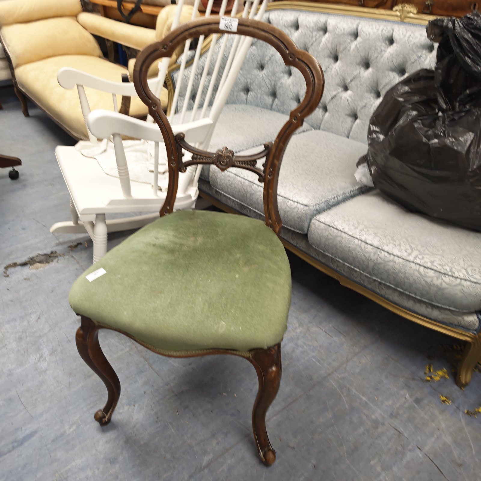 Antique Victorian mahogany chair with green upholstered seat and carved details.