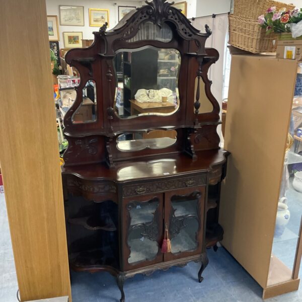 Ornate Victorian mahogany display cabinet with mirror and glazed doors.