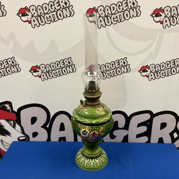 Antique Victorian oil lamp with green majolica base and brass details.