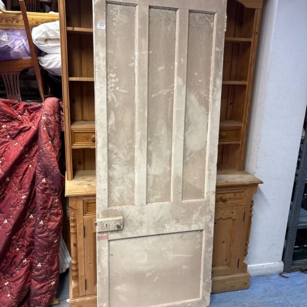 Victorian pine interior door with panel detailing and original hardware.