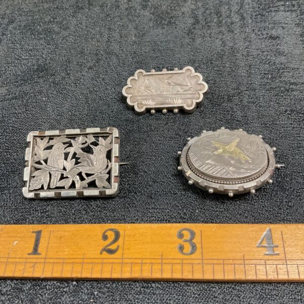 Antique Victorian silver brooch with bird motif.