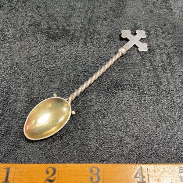 Victorian silver teaspoon with twisted stem and gilded bowl.