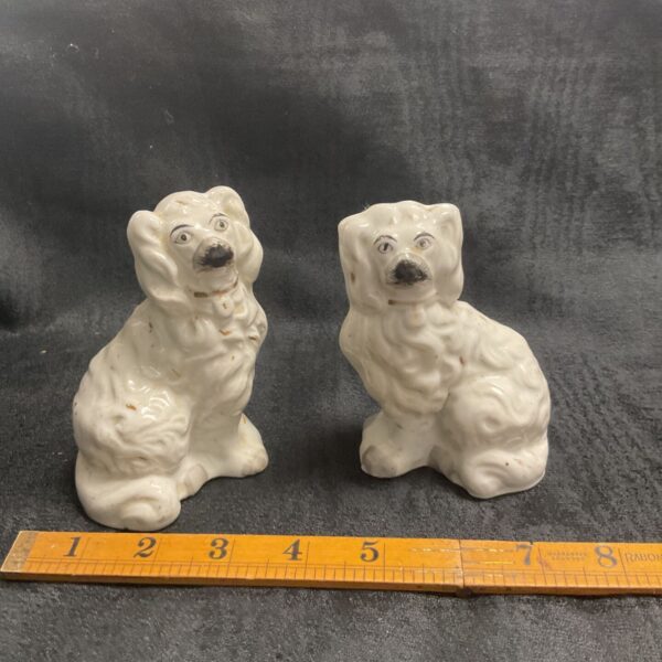 Antique Victorian Staffordshire spaniels, a charming collectible pair.