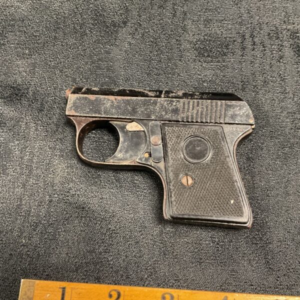 Vintage AAG starting pistol with ruler for scale.