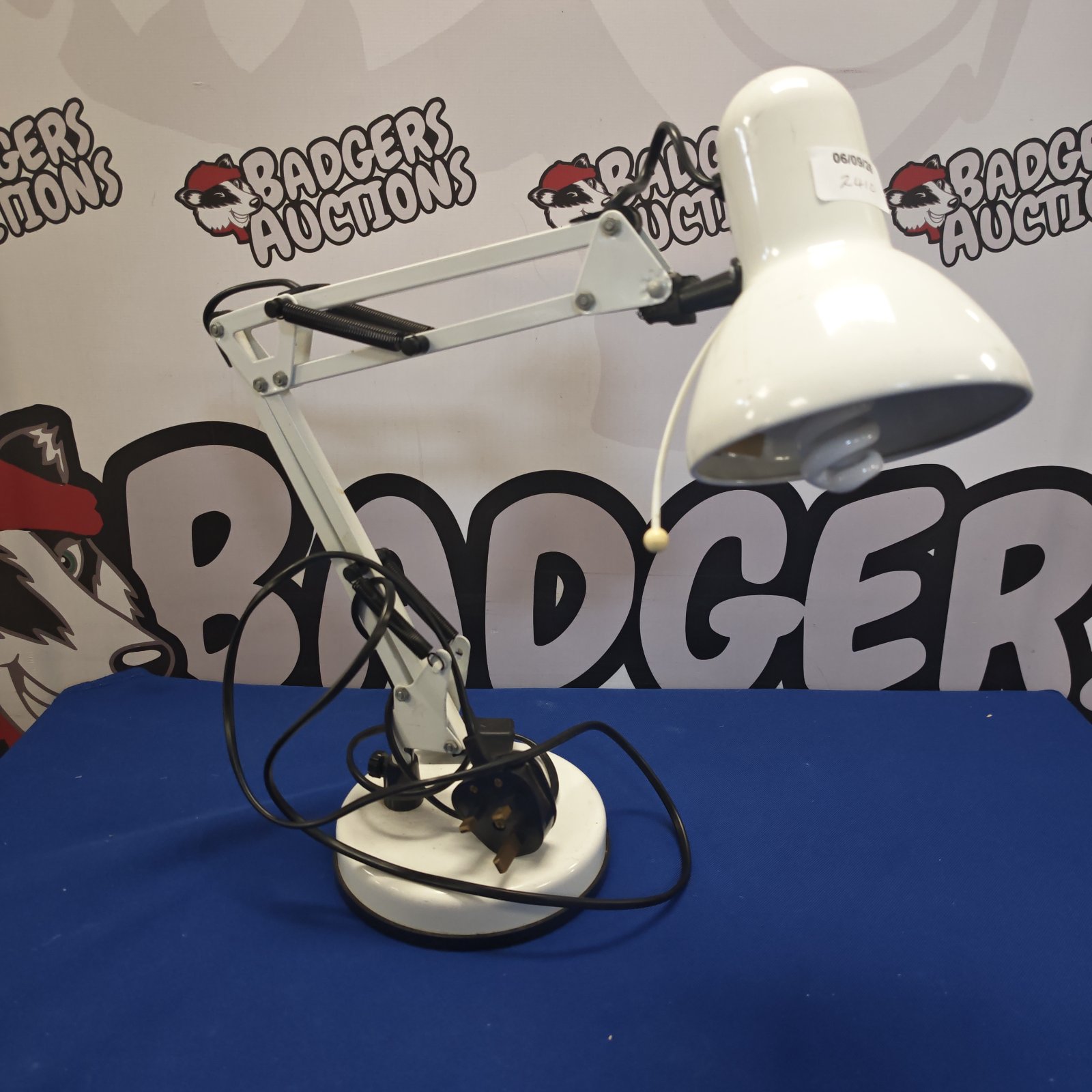 Vintage anglepoise desk lamp with adjustable arm and circular base.