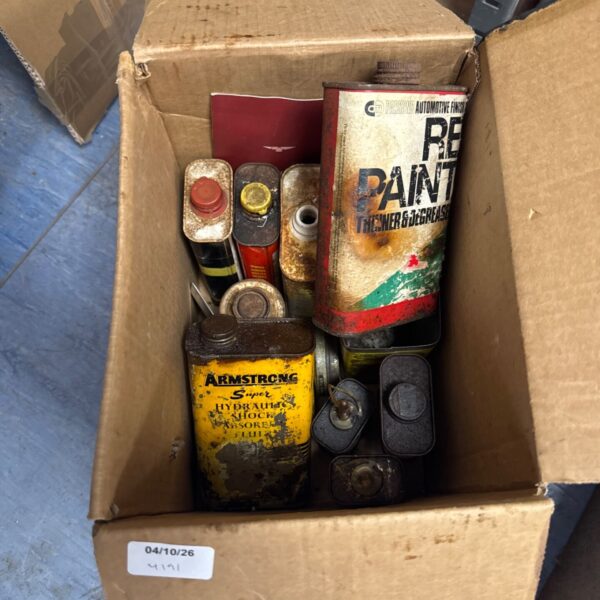 Lot of vintage automotive tins and cans, showing wear and tear.