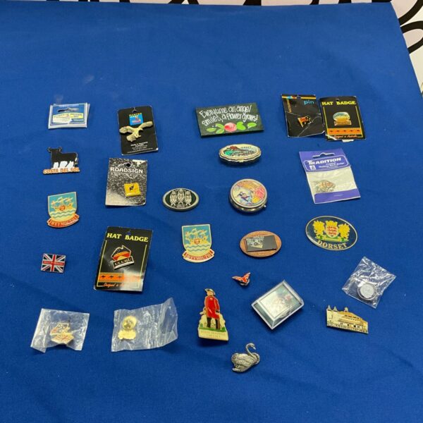 Vintage badge collection featuring enamel and pin badges.