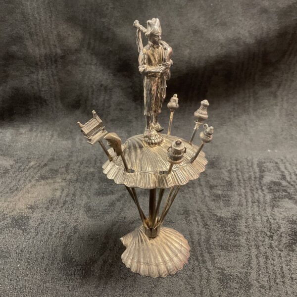 Vintage silver plated cocktail pick set with bagpiper figure.
