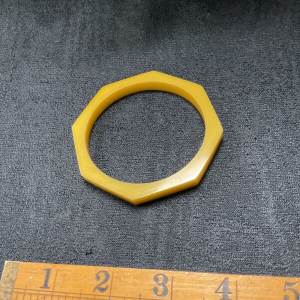Vintage yellow bakelite bangle with octagonal facets.