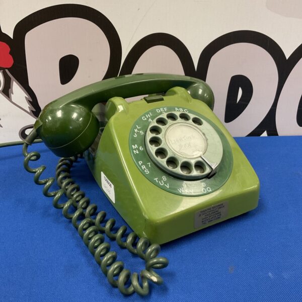 Vintage green Bakelite rotary telephone with coiled cord.