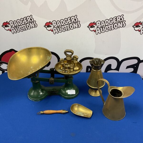 Vintage balance scales with brass vase and jug on display.