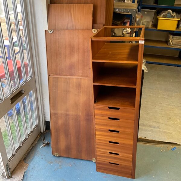 Vintage wooden bedroom wardrobe with shelving and doors.