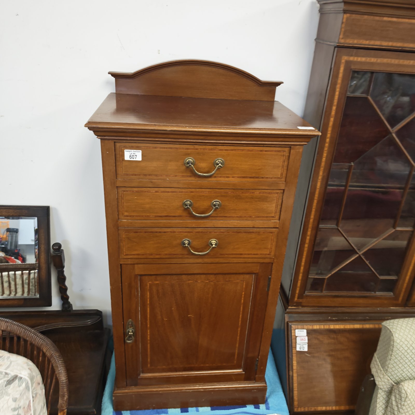 Vintage inlaid bedside cabinet with three drawers and cupboard.