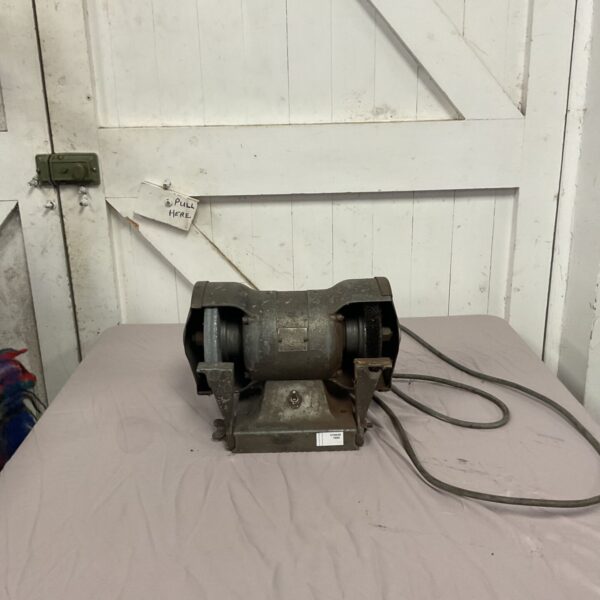 Vintage double-ended bench grinder for metalworking and tool sharpening.