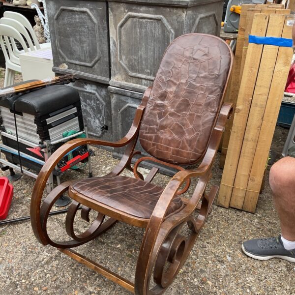 Vintage bentwood rocking chair with leather patchwork detailing.
