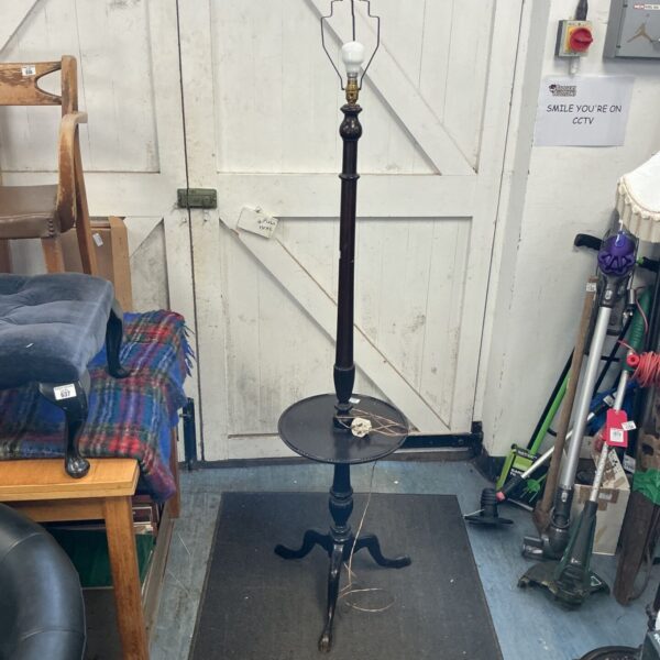 Vintage black floor lamp with tripod legs, ideal for home decor.