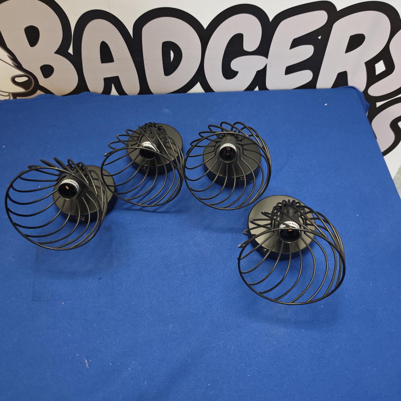 Set of four vintage black metal wall lights.