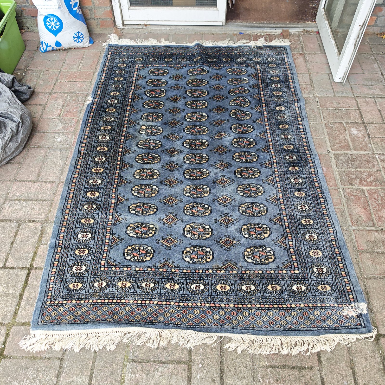 Vintage blue geometric rug with a traditional pattern.